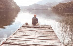 man sitting on dock